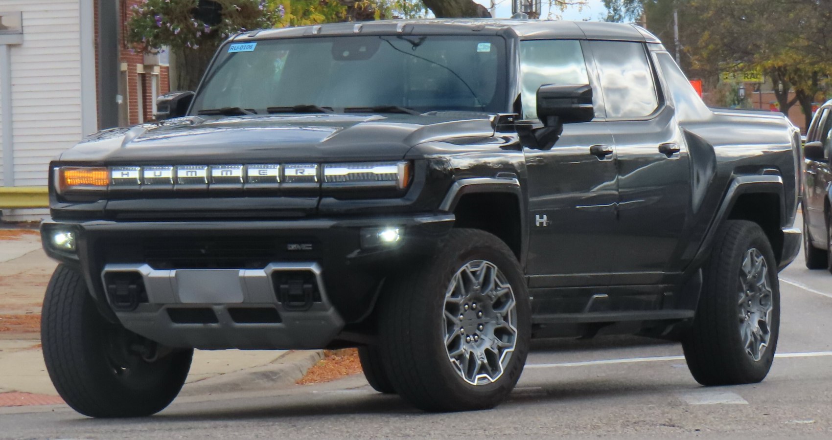 Front and side view showcasing bold grille lighting and rugged wheels