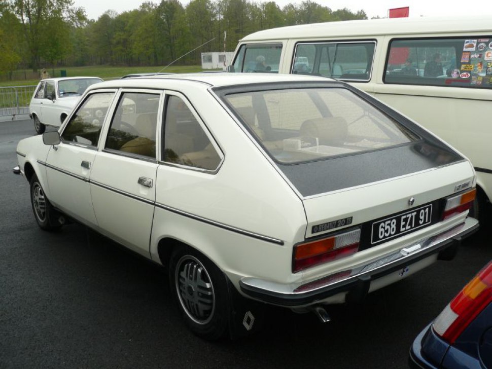 White classic hatchback with large rear window and distinctive tail lights.