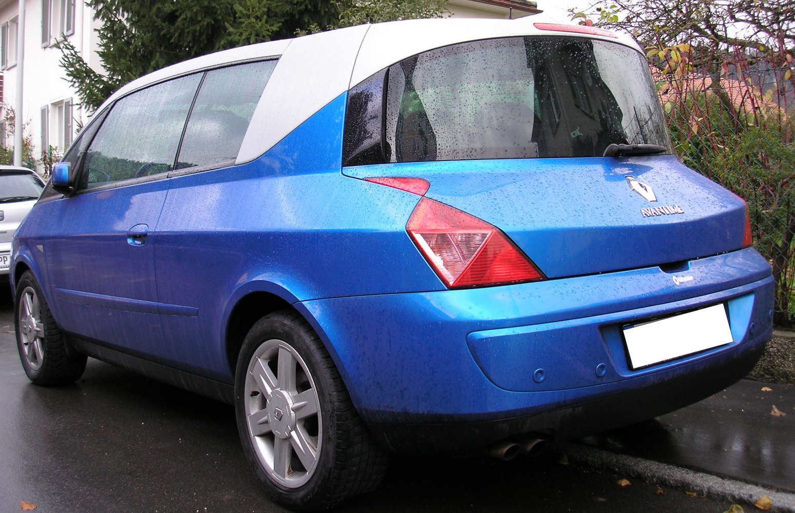 Rear and side view of a vehicle with unique, angular design and triangular tail lights.