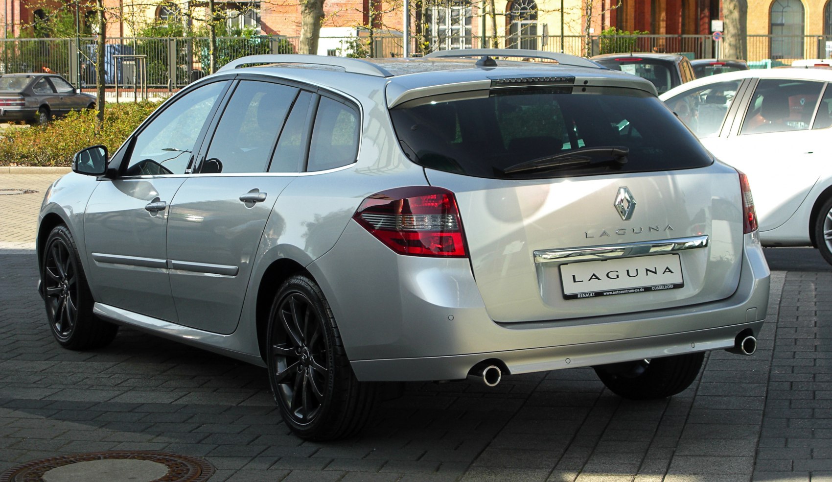 Silver estate car rear view with dual exhausts and roof rails