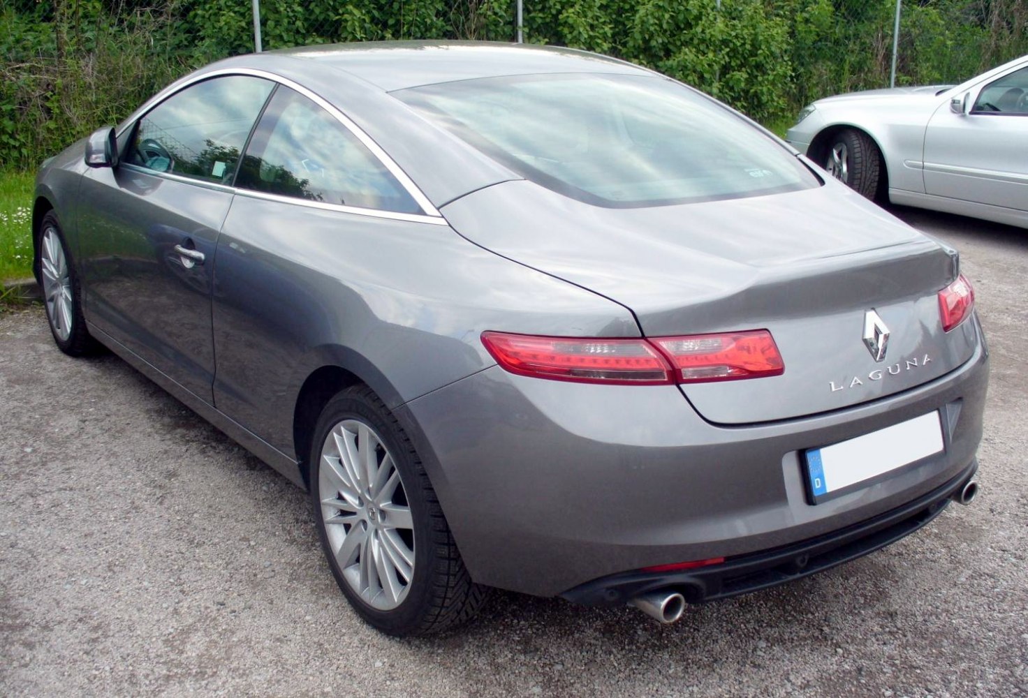 Sleek rear with horizontal tail lights and dual exhausts