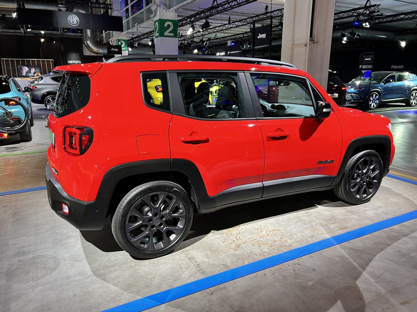 Side view of red compact SUV with black alloy wheels and distinctive rear light design