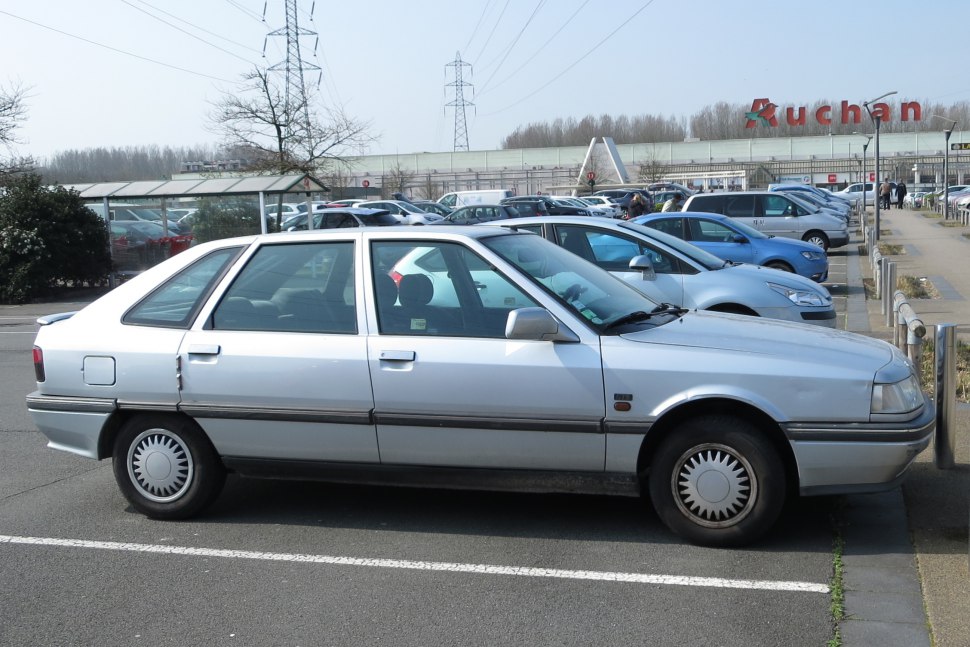 Silver classic hatchback parked, side profile view
