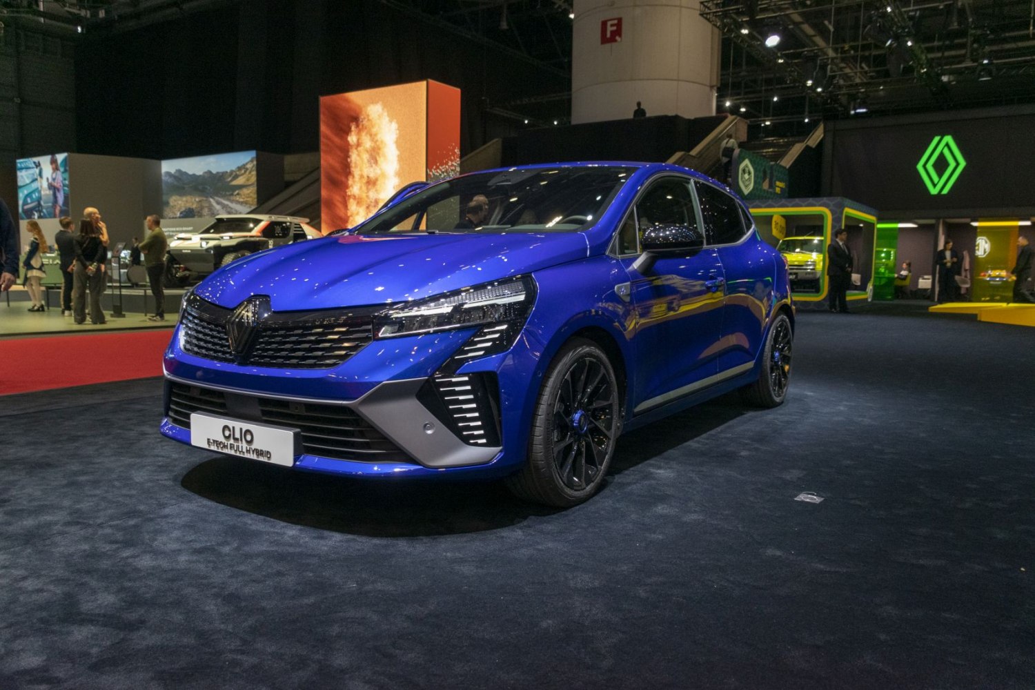 Blue hatchback with modern headlights and front grille design