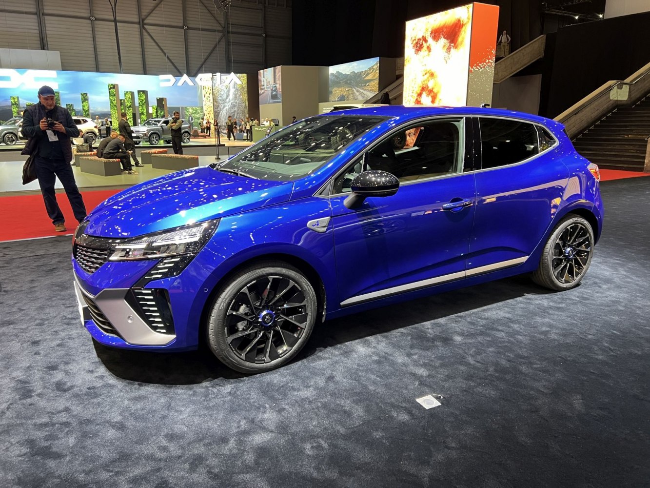 Blue hatchback with black alloy wheels and modern headlights