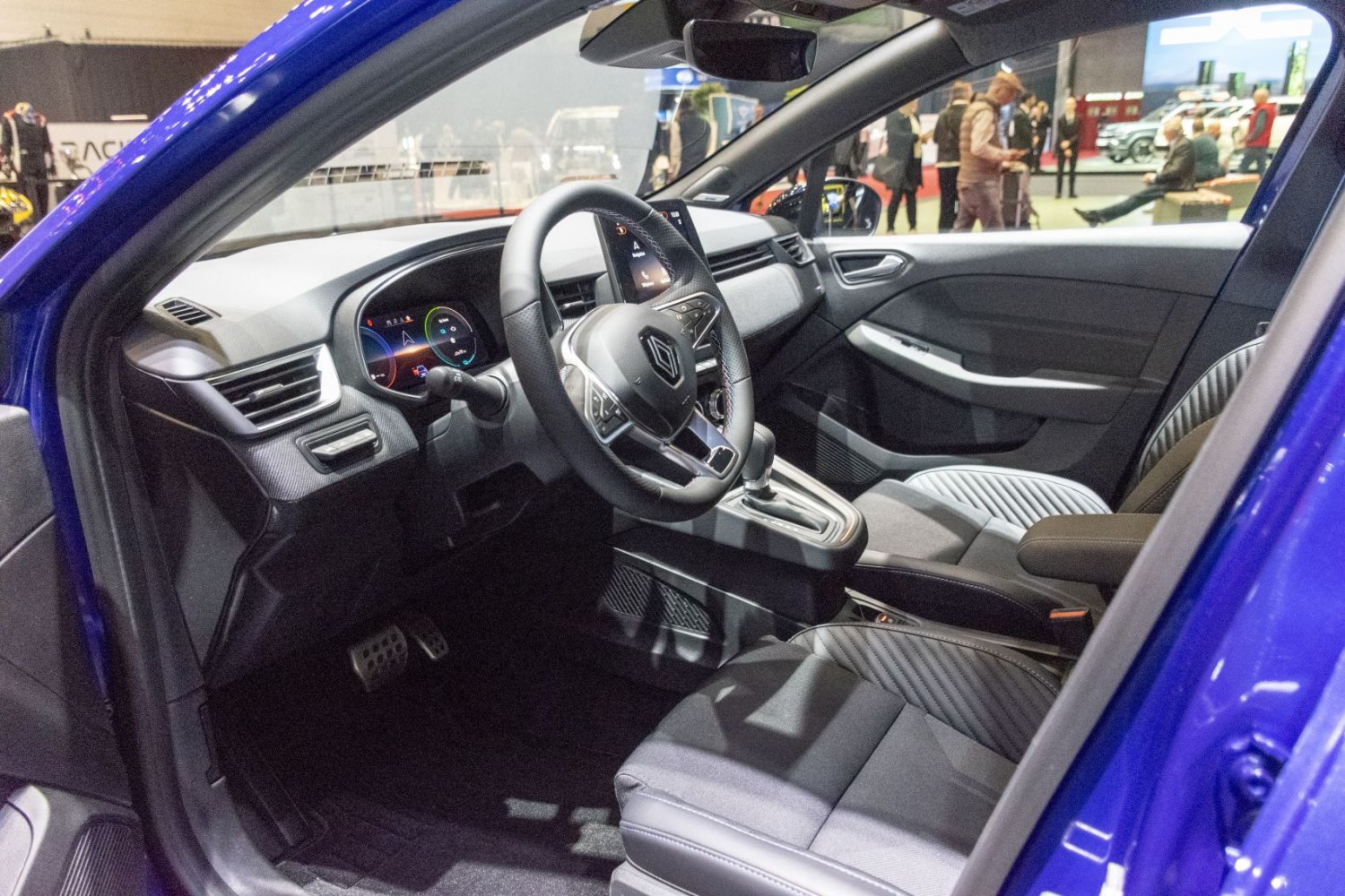 Modern dashboard and steering wheel with digital displays and control buttons