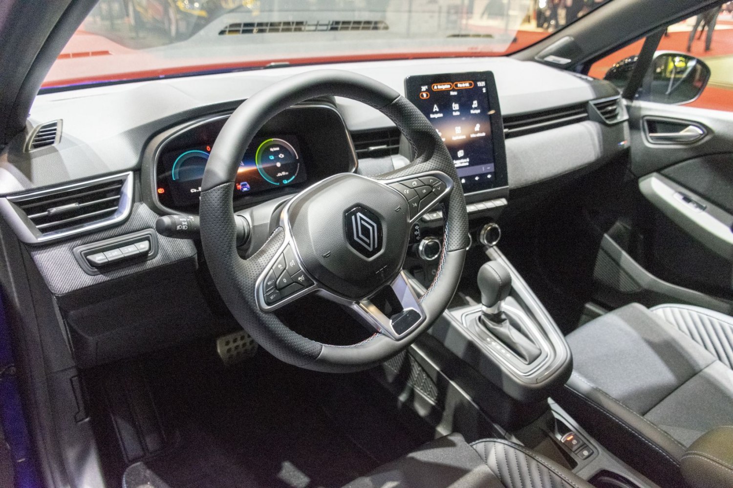 Digital instrument cluster and vertical touchscreen infotainment with modern steering wheel and gear shifter