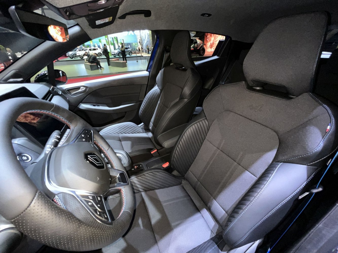 Sporty front seats and multifunction steering wheel in modern car interior