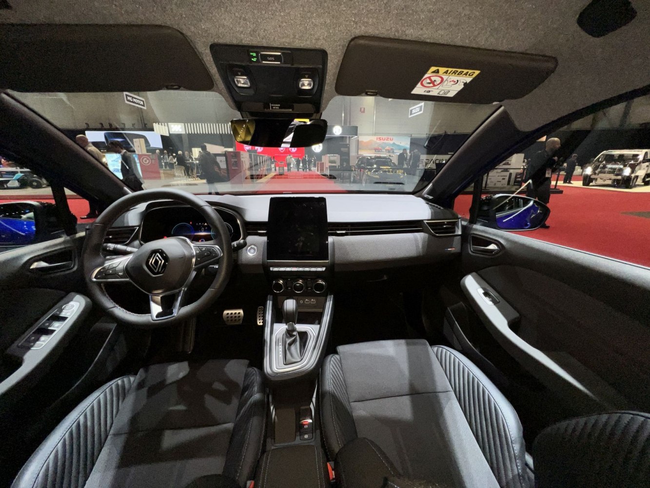 Modern car interior with digital instrument cluster and central touchscreen.