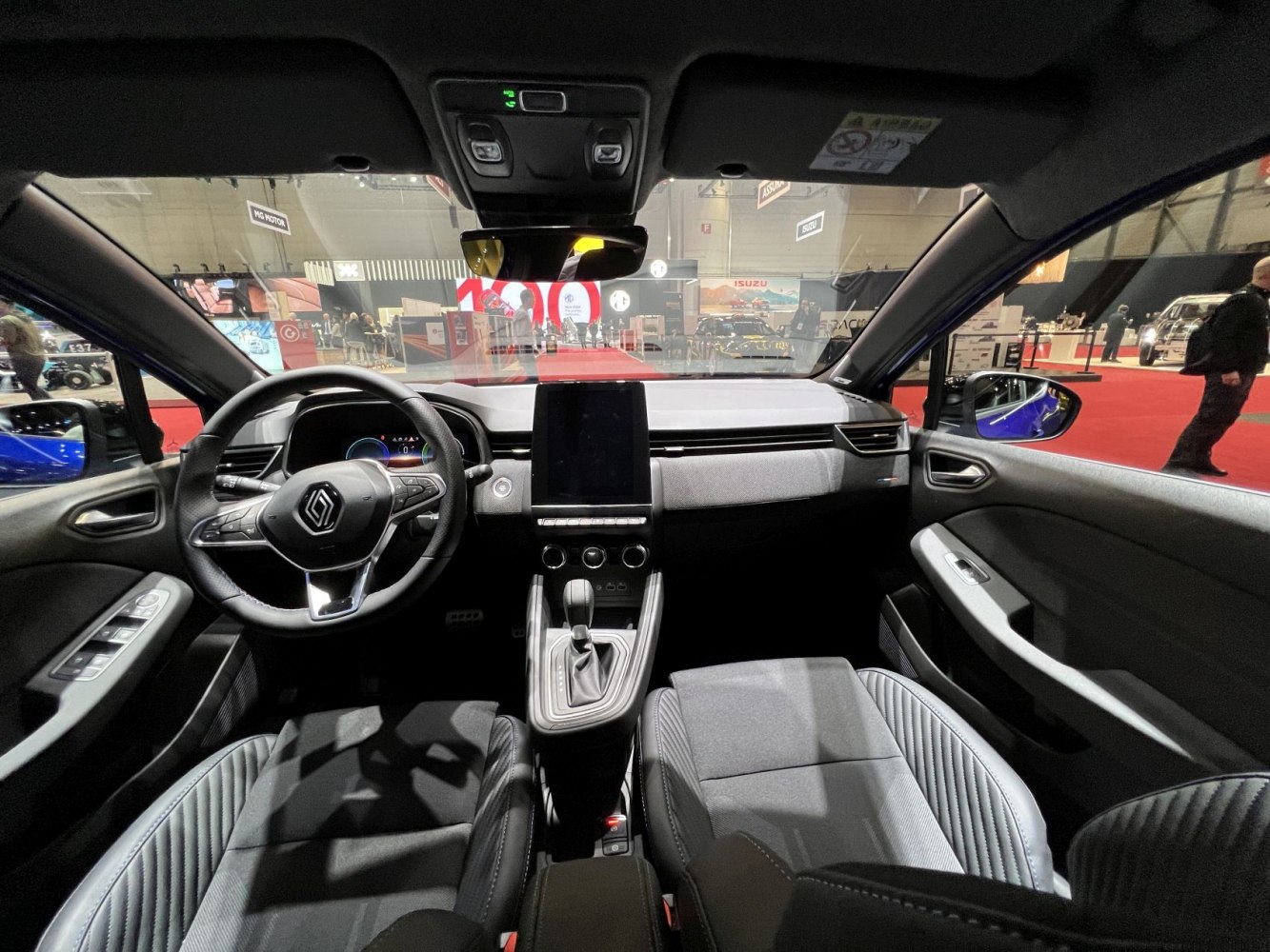 Dashboard and steering wheel with central touchscreen and console.