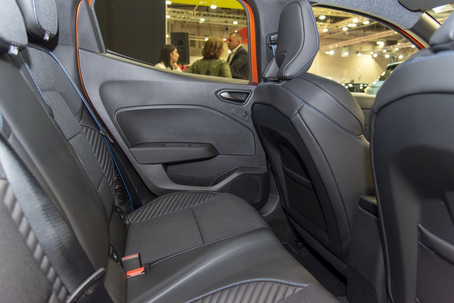 Rear seat interior with upholstery and blue stitching
