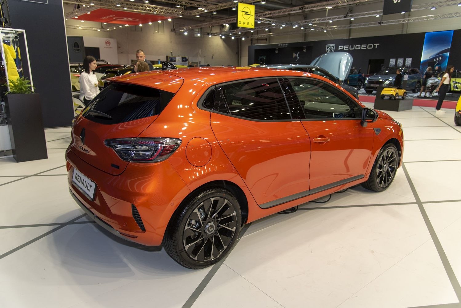 Rear and side profile of orange compact hatchback with alloy wheels