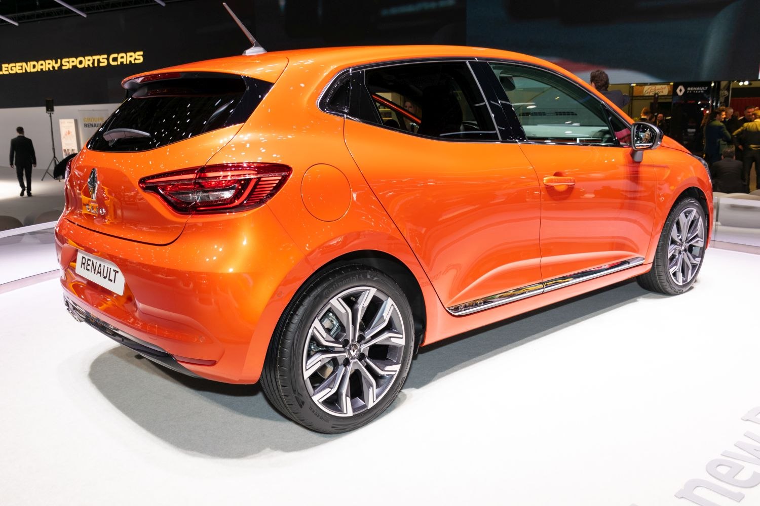 Rear side view of bright orange hatchback with stylish alloy wheels