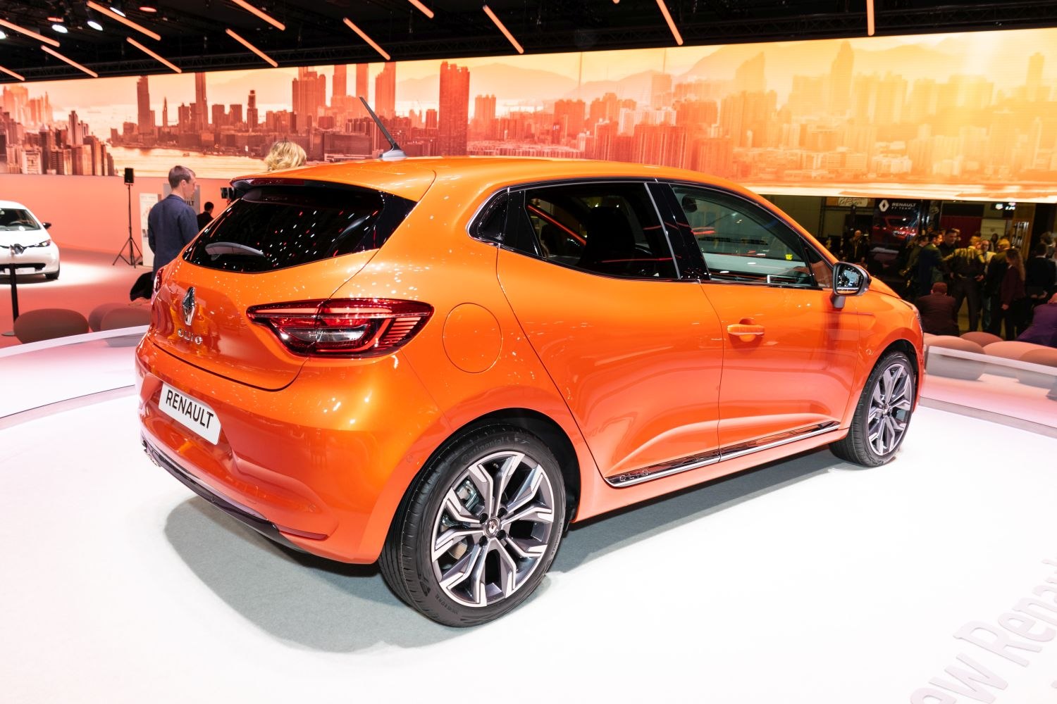 Orange hatchback showing rear and side profile with alloy wheels.