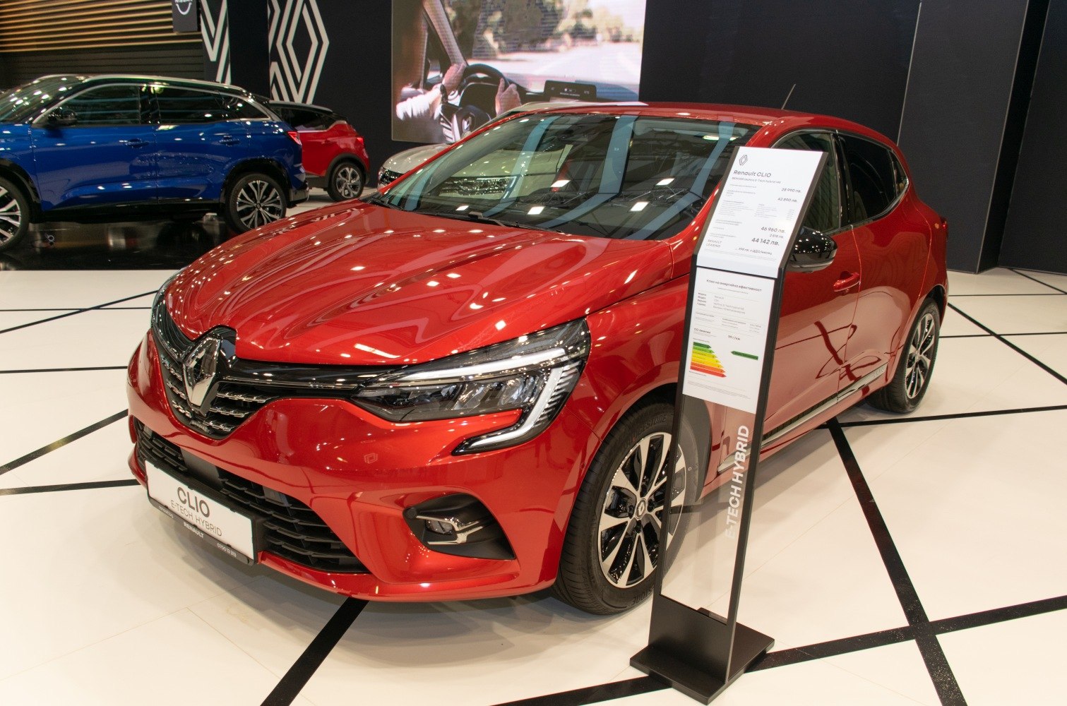 Red compact hatchback with LED headlights and multi-spoke alloy wheels