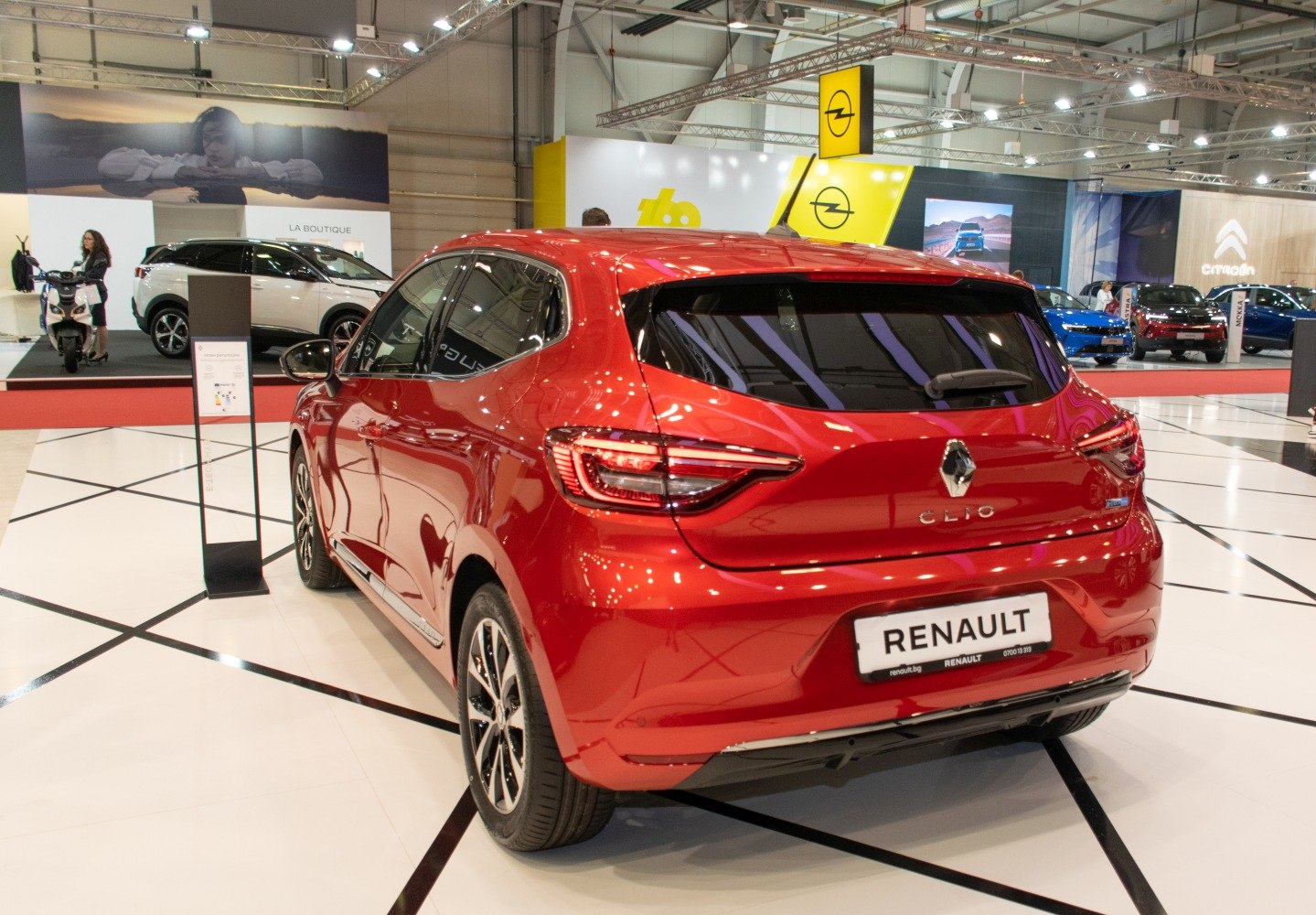 Red hatchback rear view with sleek taillights and alloy wheels