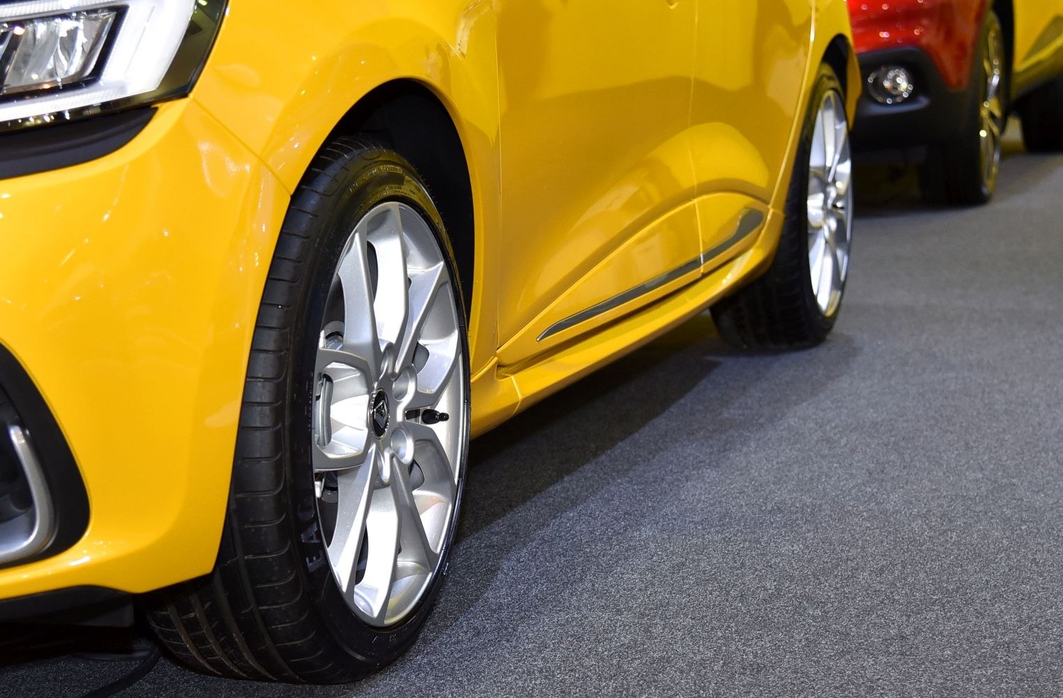 Alloy wheel and side panel trim on a yellow car