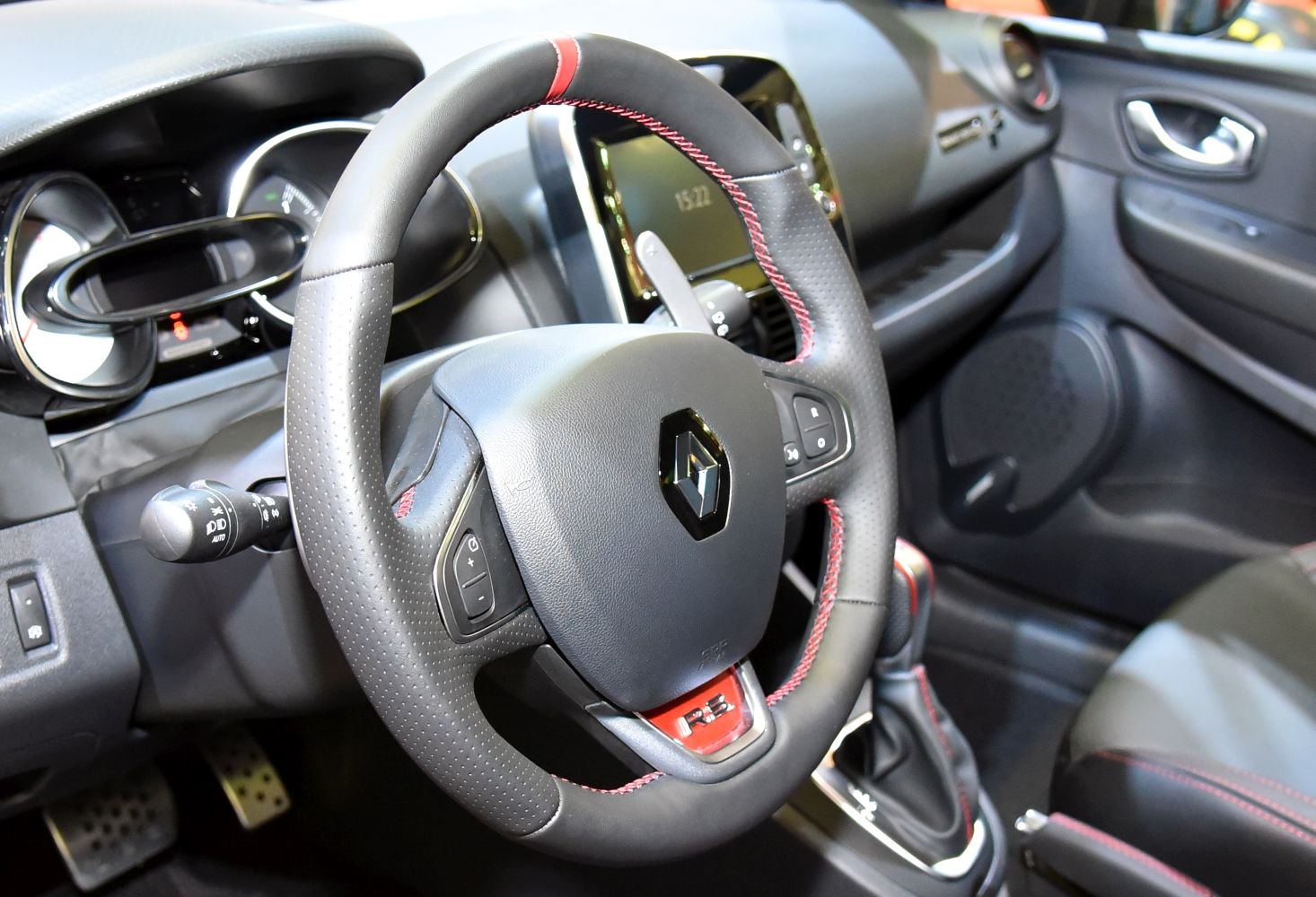 Sporty steering wheel with red stitching and modern dashboard design
