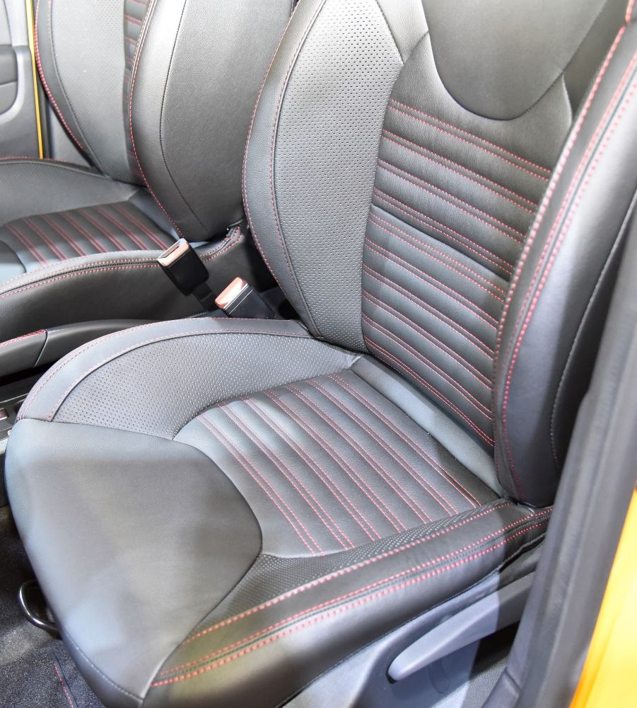 Black leather car seats with red stitching detail