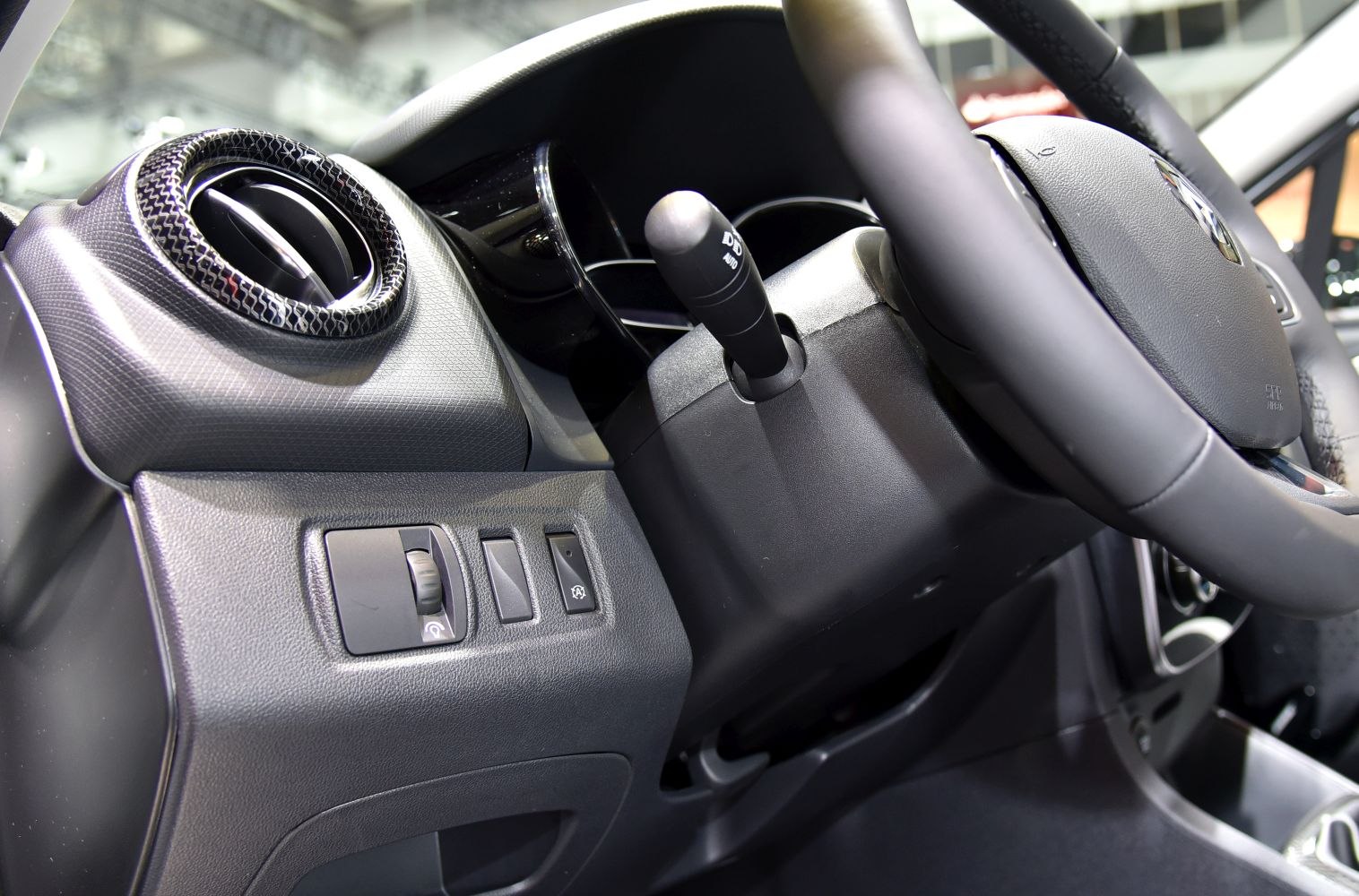 Dashboard controls and steering column stalk with air vent of car interior