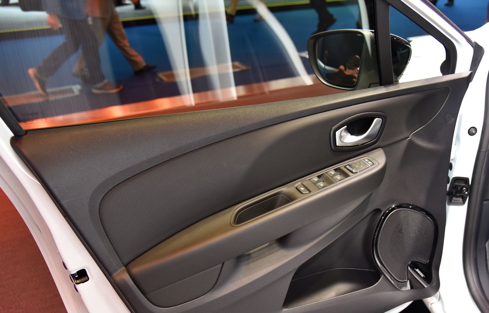 Car interior door panel with power window controls and Bose speaker