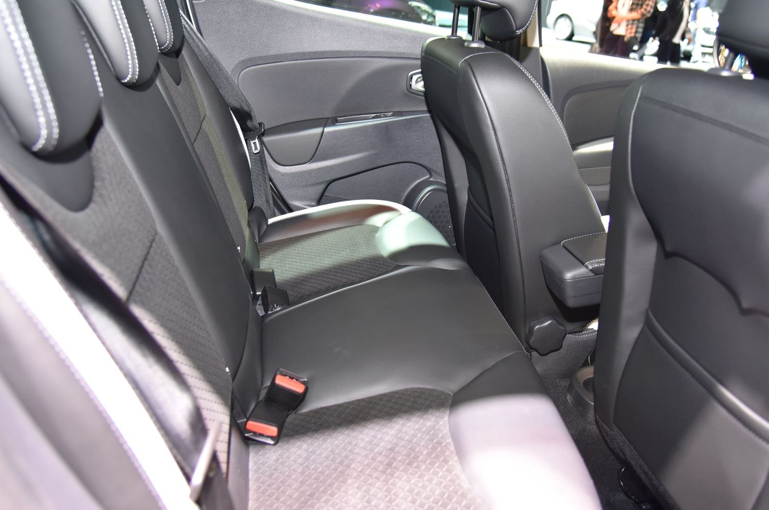 Modern rear seating with stitched upholstery and seat belts.