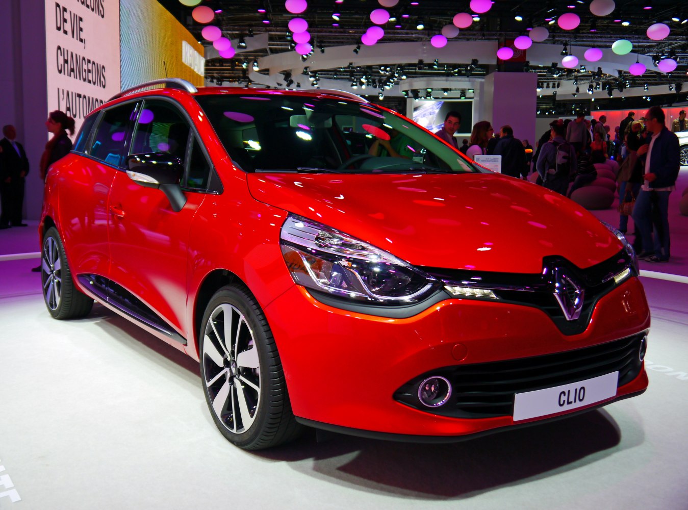 Sleek red compact wagon with modern headlights and alloy wheels