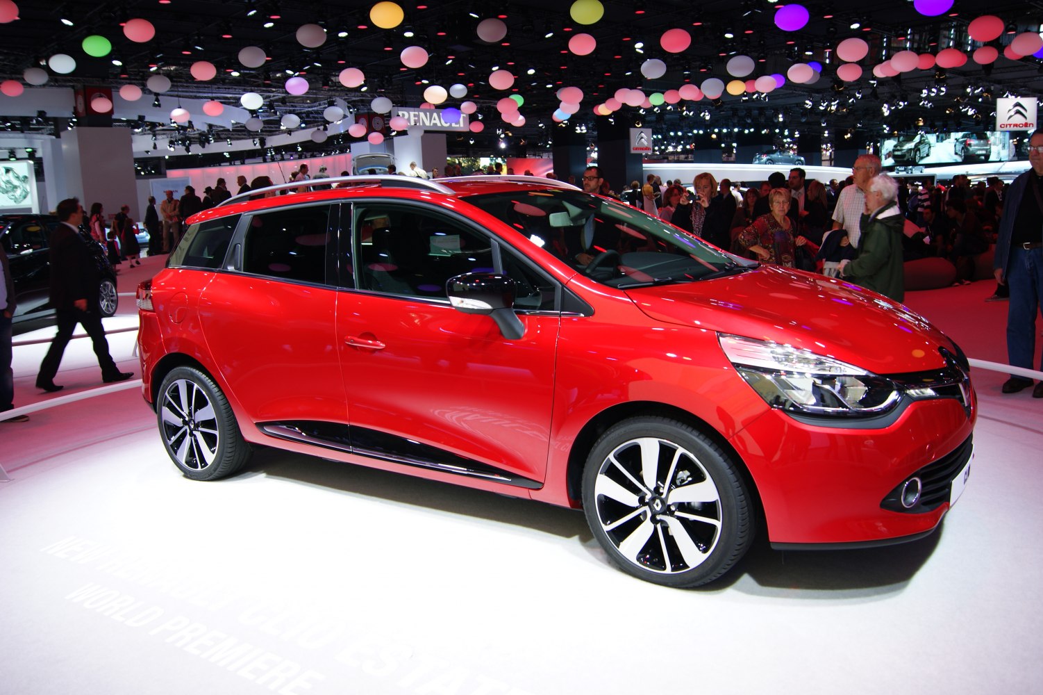 Red station wagon with modern alloy wheels in motor show