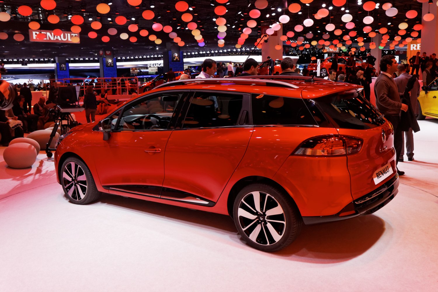 Red station wagon with alloy wheels and roof rails
