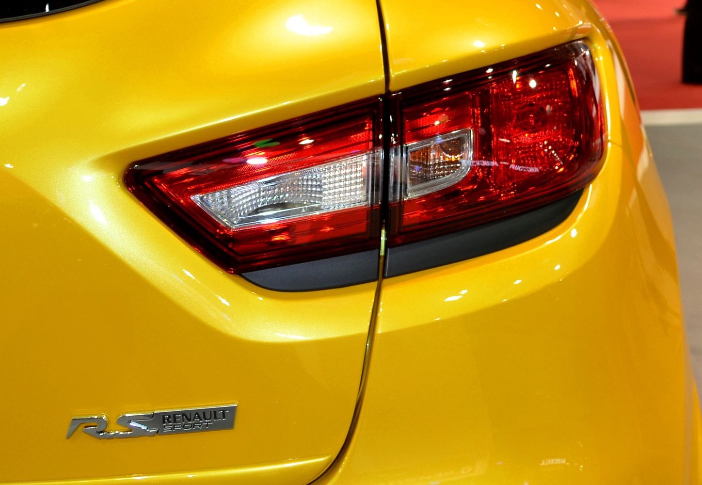 Modern rear light cluster with RS sport badge on yellow hatchback