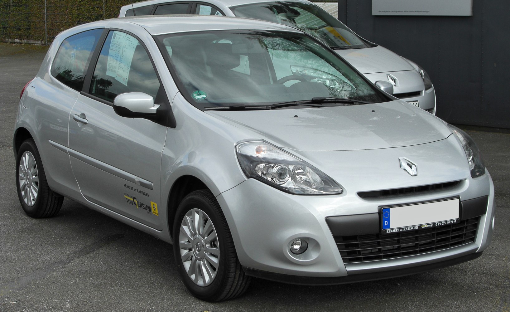 Front angled view with headlights, grille, and side mirrors