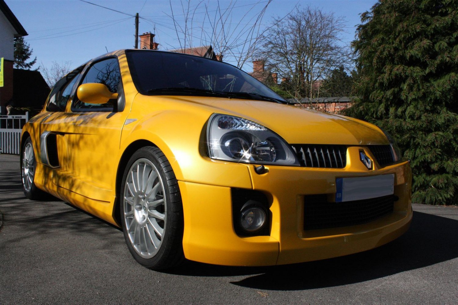 Yellow sporty compact hatchback with alloy wheels