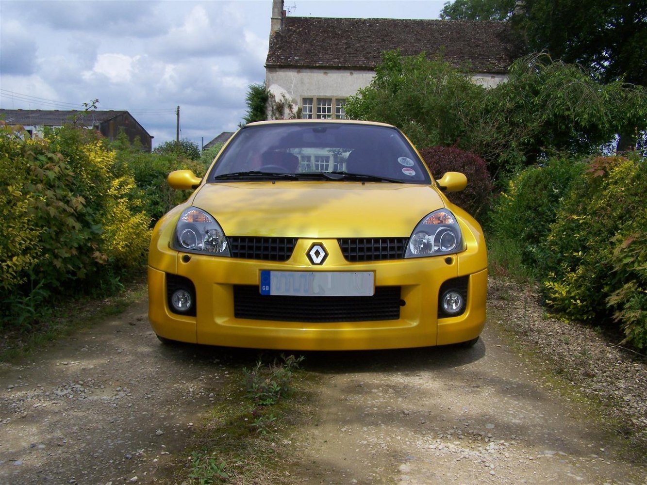 Front view showing headlights, grille, and bumper in yellow car