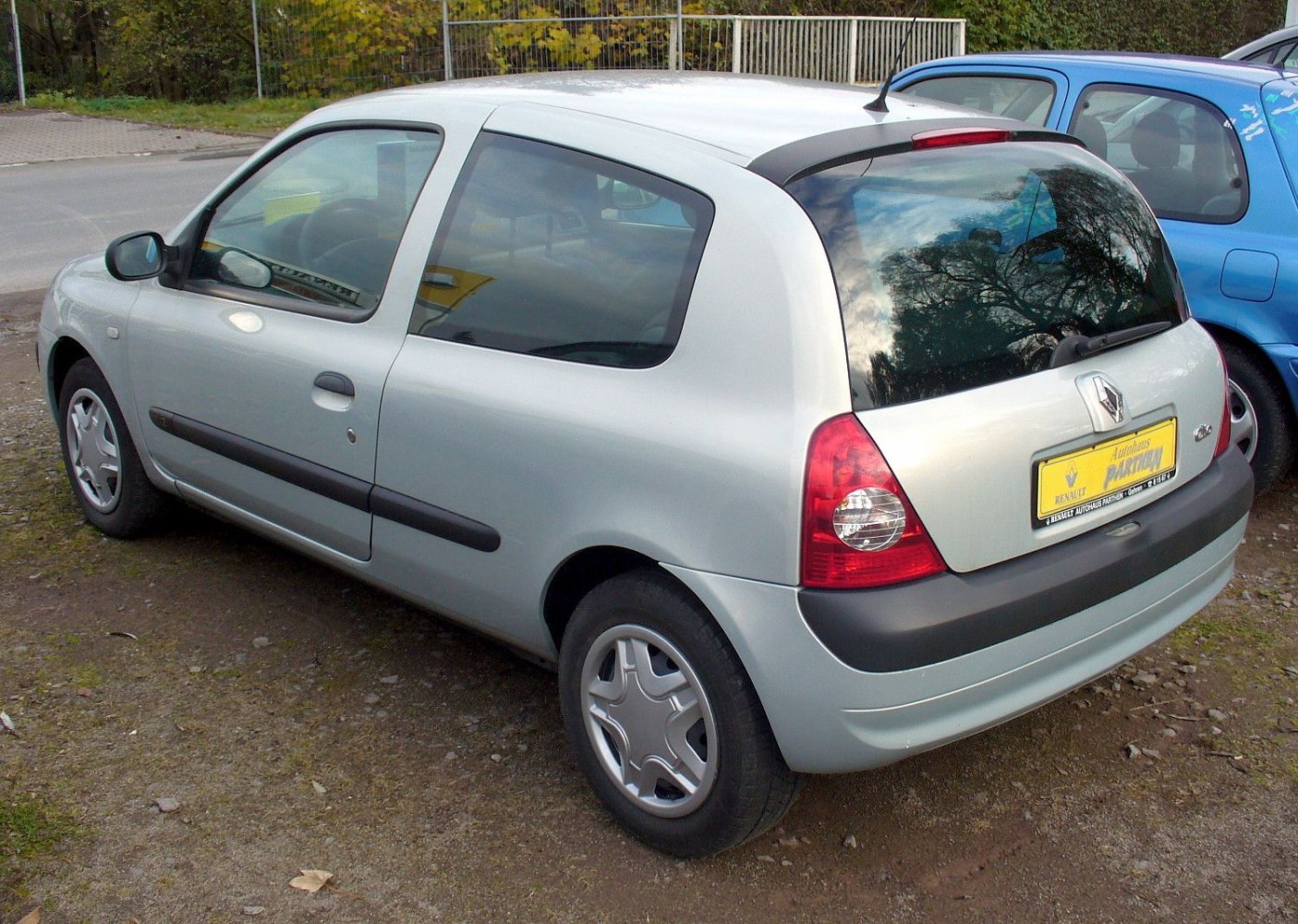 Silver 3-door hatchback rear side with tail lights and black side molding