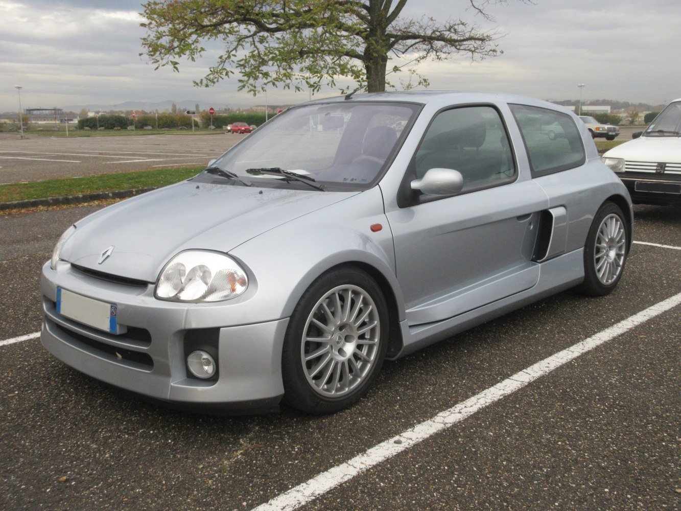 Silver sporty compact hatchback with side air intakes and alloy wheels
