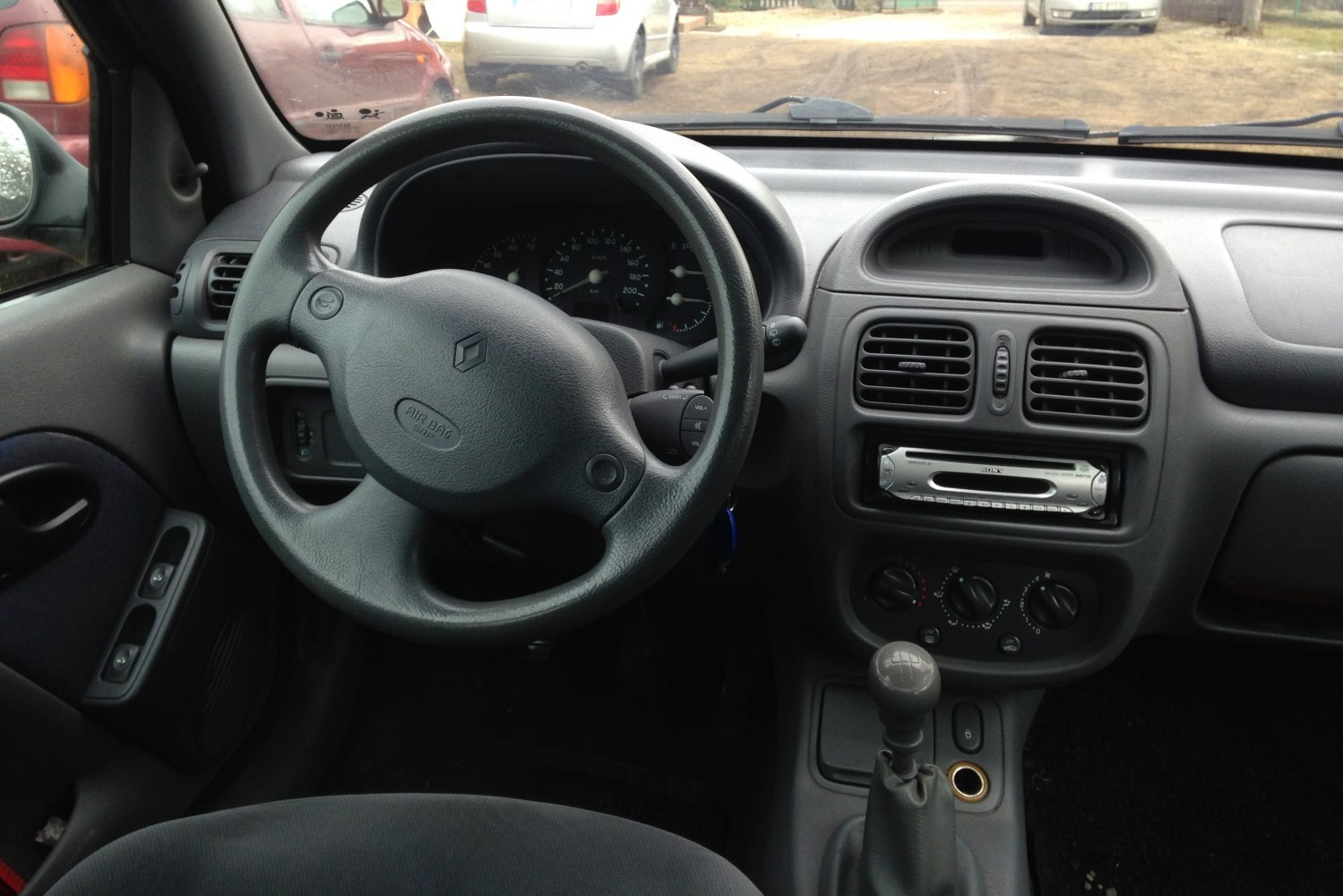Steering wheel, dashboard, manual gear shift in car interior