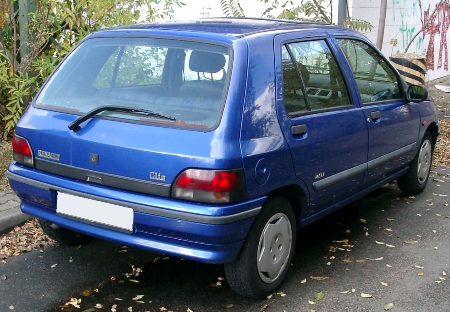Rear three-quarter view of a blue compact hatchback with distinctive rear lights and rear window wiper