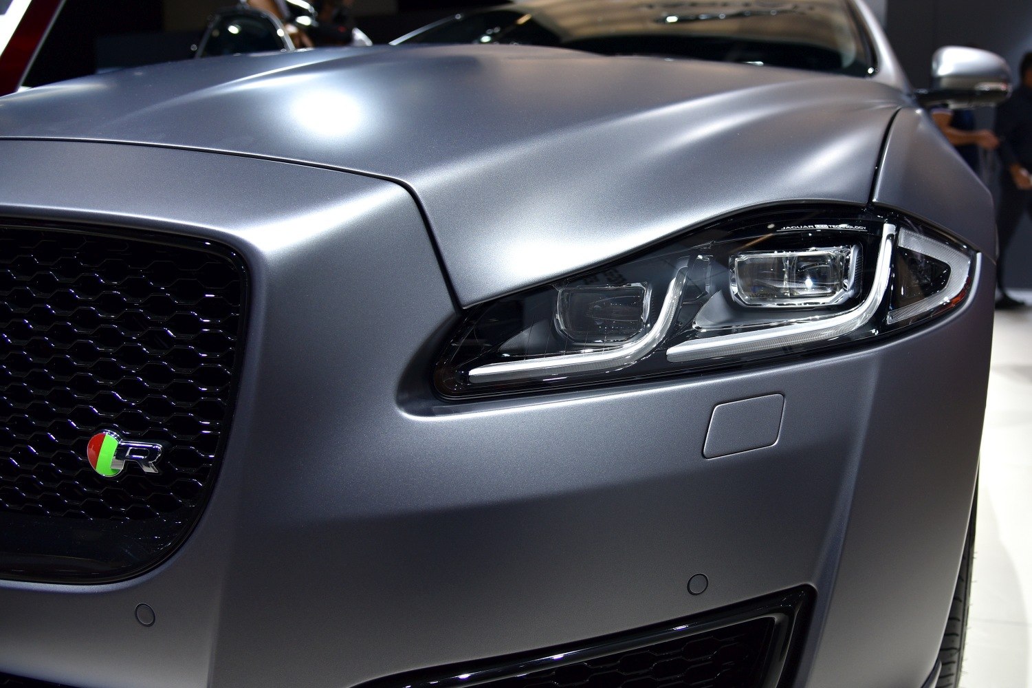 Close-up of front headlight and honeycomb grill with R badge