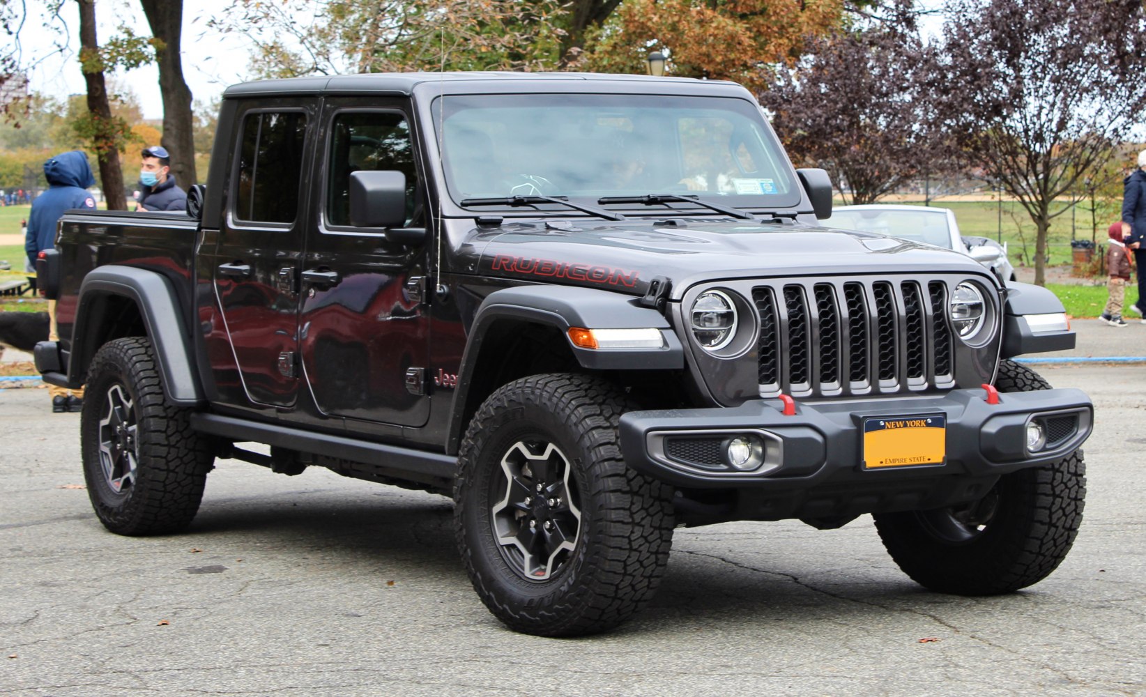 Four-door pickup truck with off-road tires and seven-slot grille