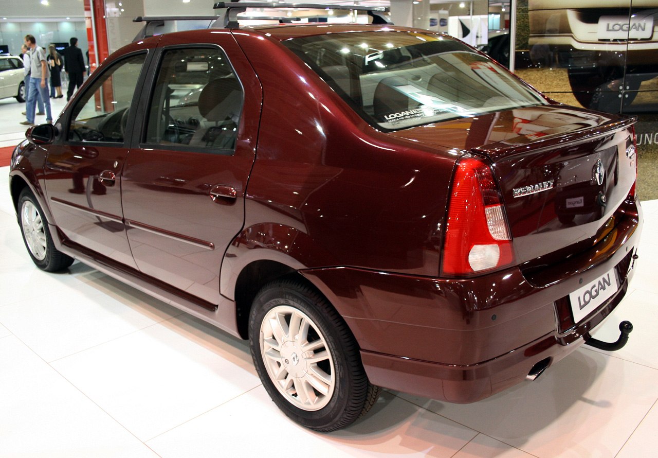 Rear side view of maroon sedan with roof rails and tow hook.