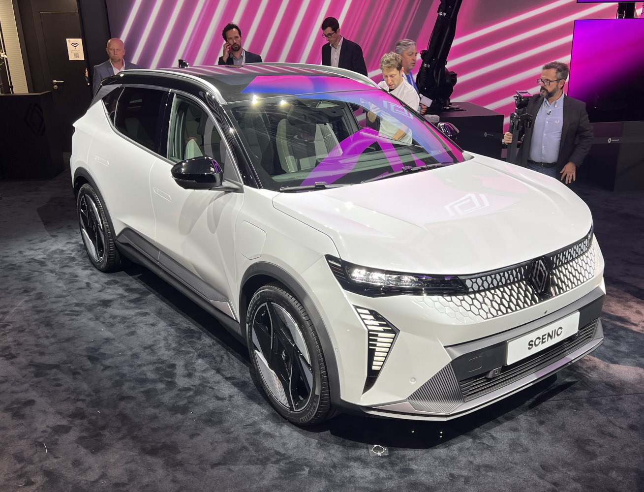 Front side view of modern electric SUV with LED headlights and black roof