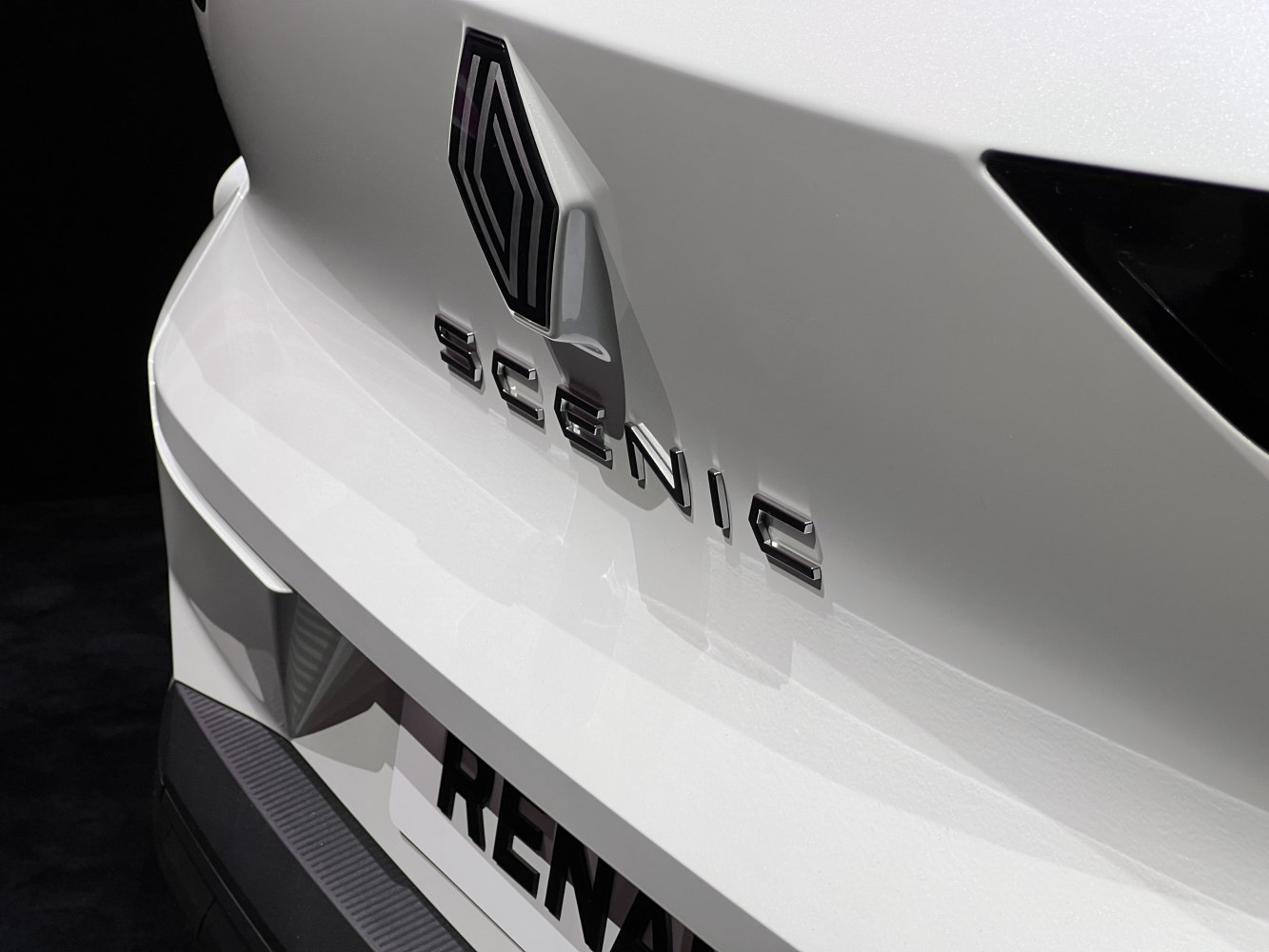 Close-up of a vehicle's rear emblem and model badge in sleek design