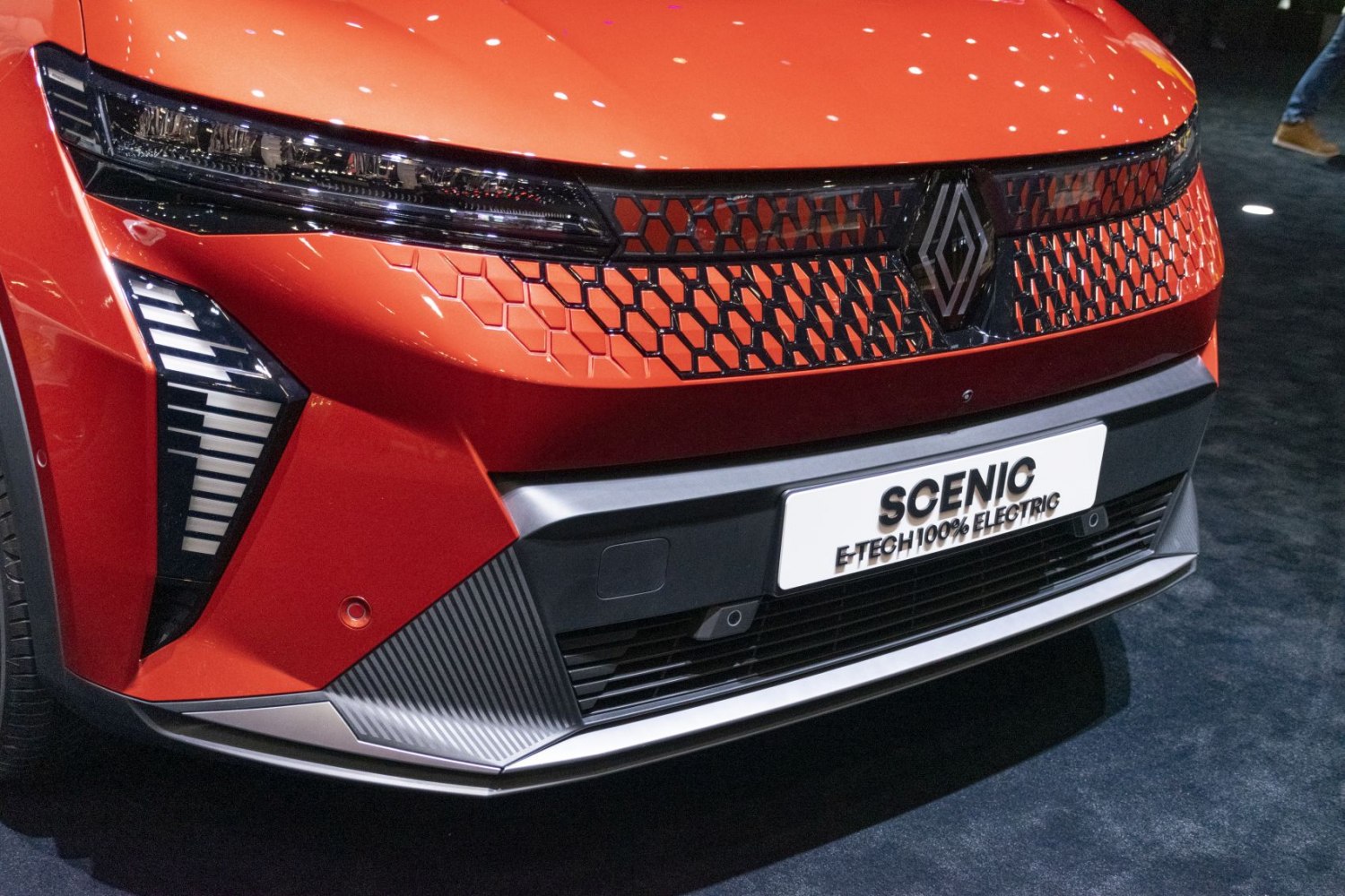 Futuristic front grille with hexagonal pattern and sleek LED headlights