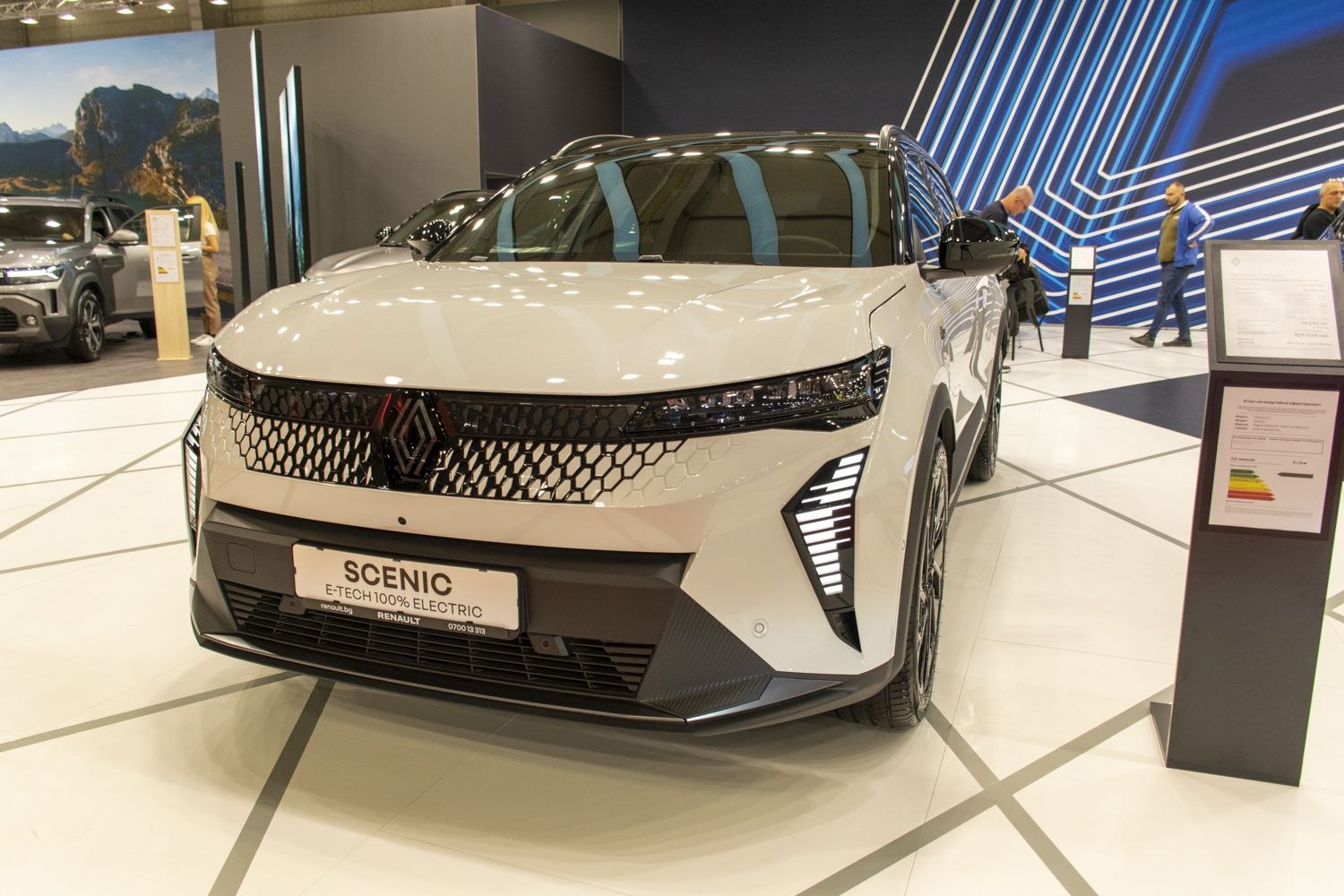 Front grille with hexagonal pattern and vertical LED daytime running lights.