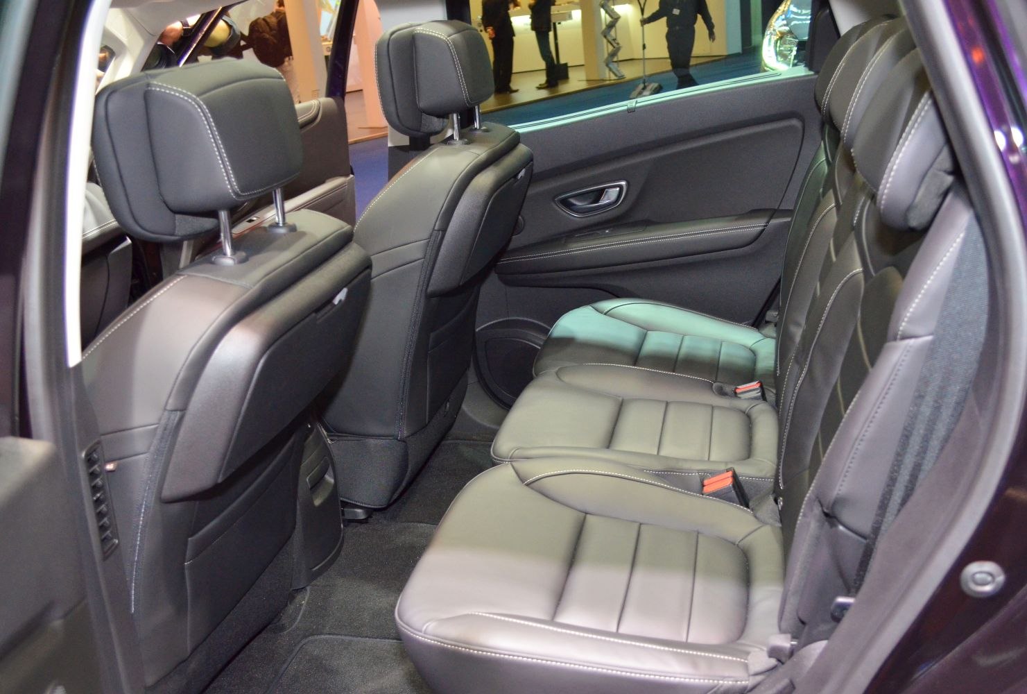 Rear leather seats with stitching and spacious cabin interior