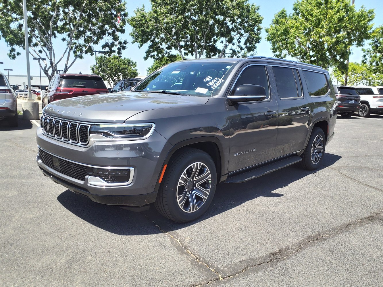 Front side exterior shows bold grille, LED headlights, alloy wheels.