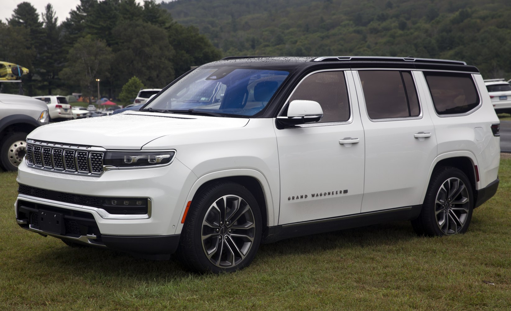 White SUV with LED headlights and multi-slot grille