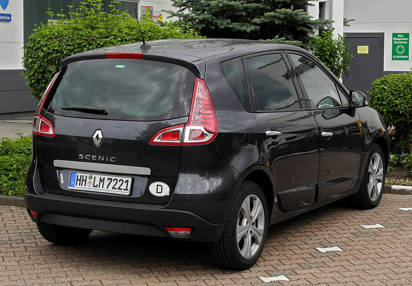 Rear view with vertical taillights and hatchback rear door.