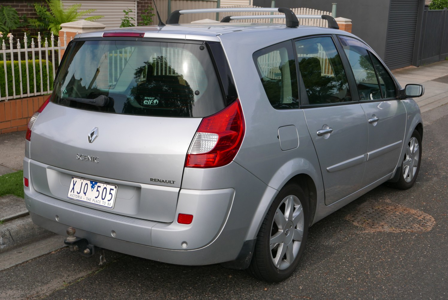 Rear view showcasing tail lights, rear window, and roof rails