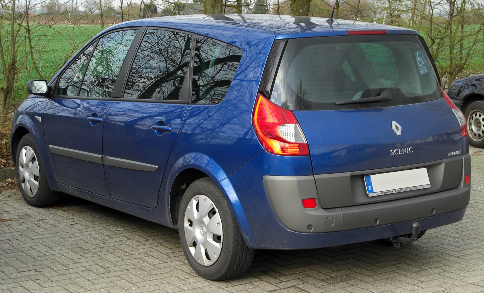 Side and rear view showing rear lights, bumper, and window design.
